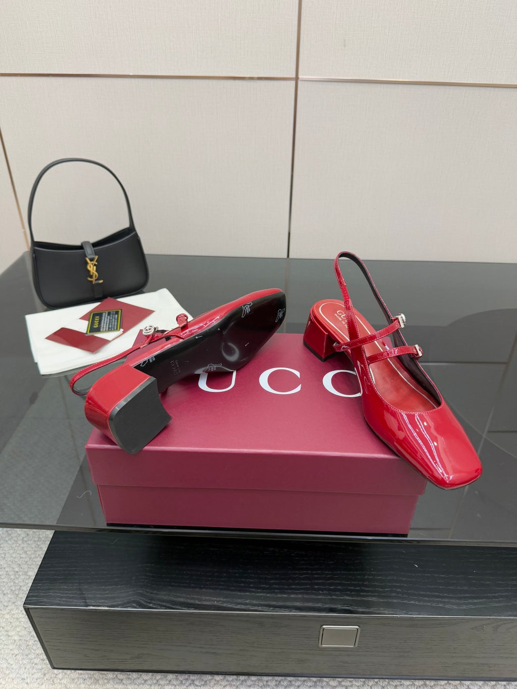 Gucci women’s red patent heels on box, slingback strap and block heel