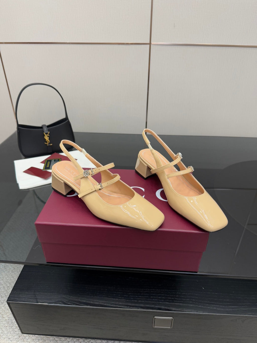 Beige patent leather slingback pumps with pointed toe and chunky low heel