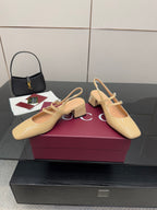 Beige patent leather slingback pumps pair with ankle strap and block heel
