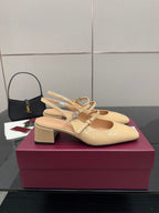 Beige patent leather slingback pump with bow detail and low chunky block heel