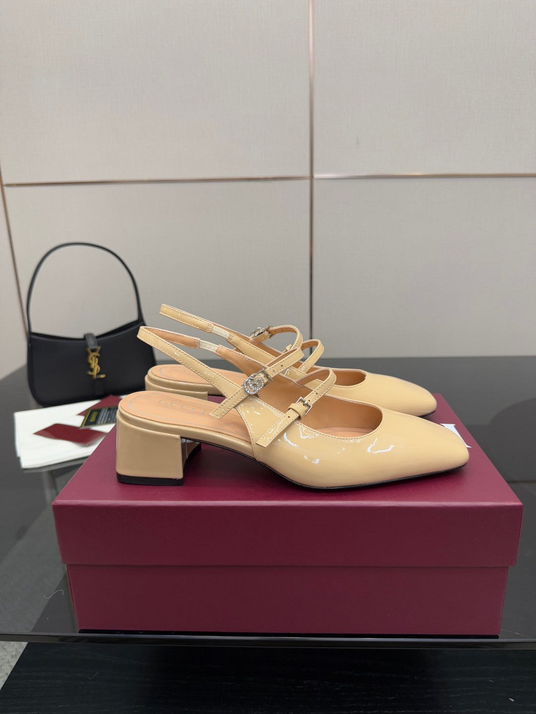 Beige patent leather slingback pump with bow detail and low chunky block heel