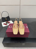 Beige patent leather slingback pumps with bow strap and low block heel