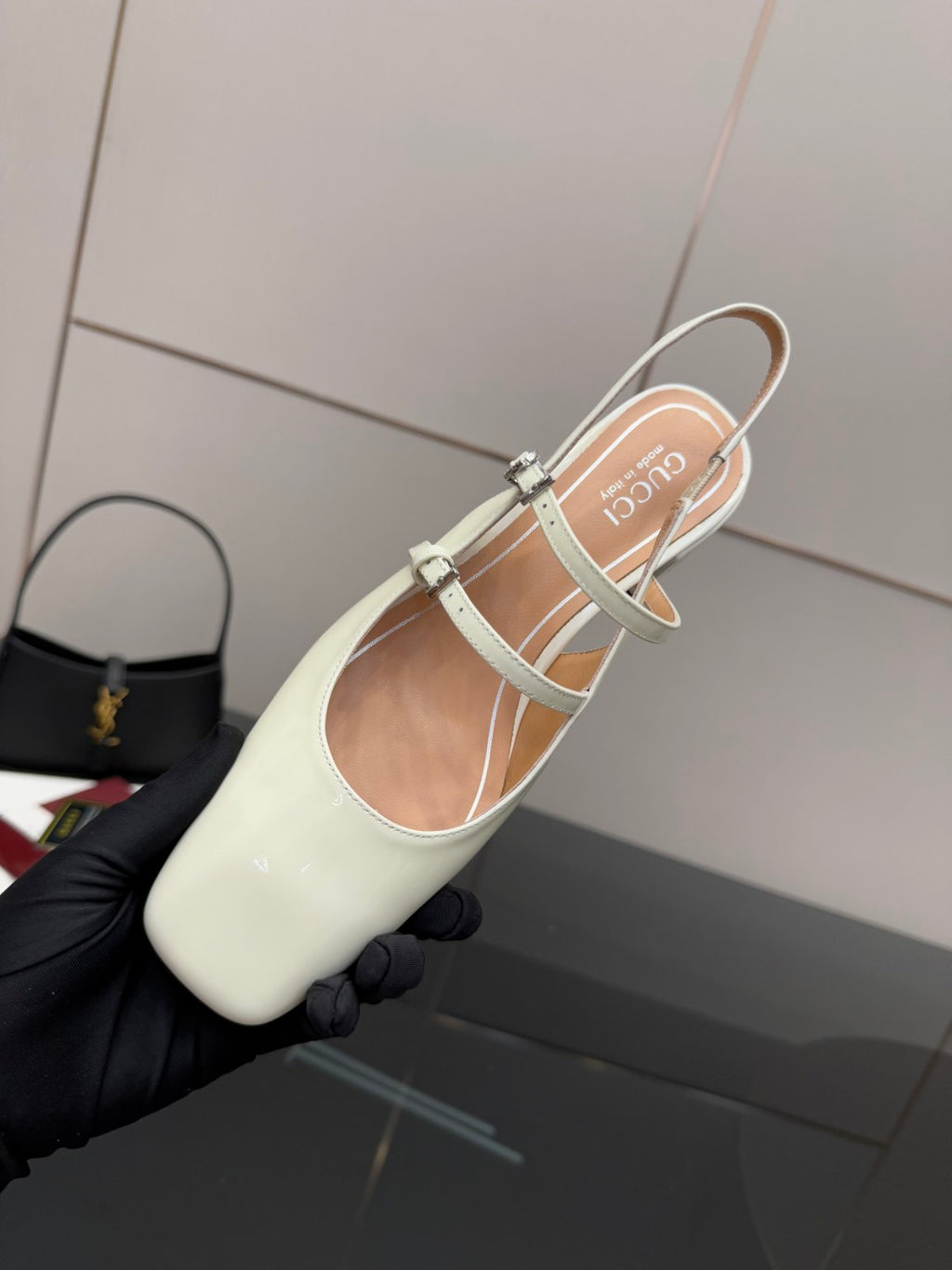 Gucci ladies' white slingback pumps with jeweled strap, shown from top angle.