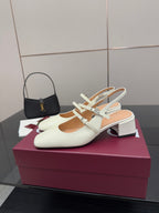 Gucci ladies' white pointed-toe slingback pumps with jeweled T-strap and block heel.