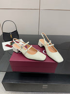 Gucci ladies' white pointed-toe slingback pumps with jeweled cross-strap and block heel.