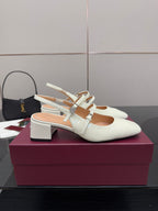 Gucci ladies' white slingback pumps with jeweled T-strap on block heel.