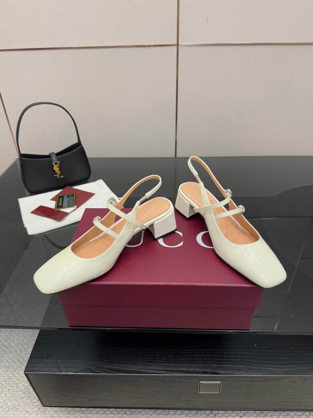 Gucci ladies' white slingback pumps with T-strap, jeweled detail, and block heel.