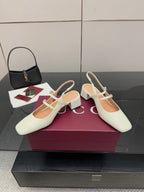 Gucci ladies' white slingback pumps with T-strap, jeweled detail, and block heel.