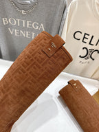 Brown suede boot shaft with small Fendi tag and textured FF pattern