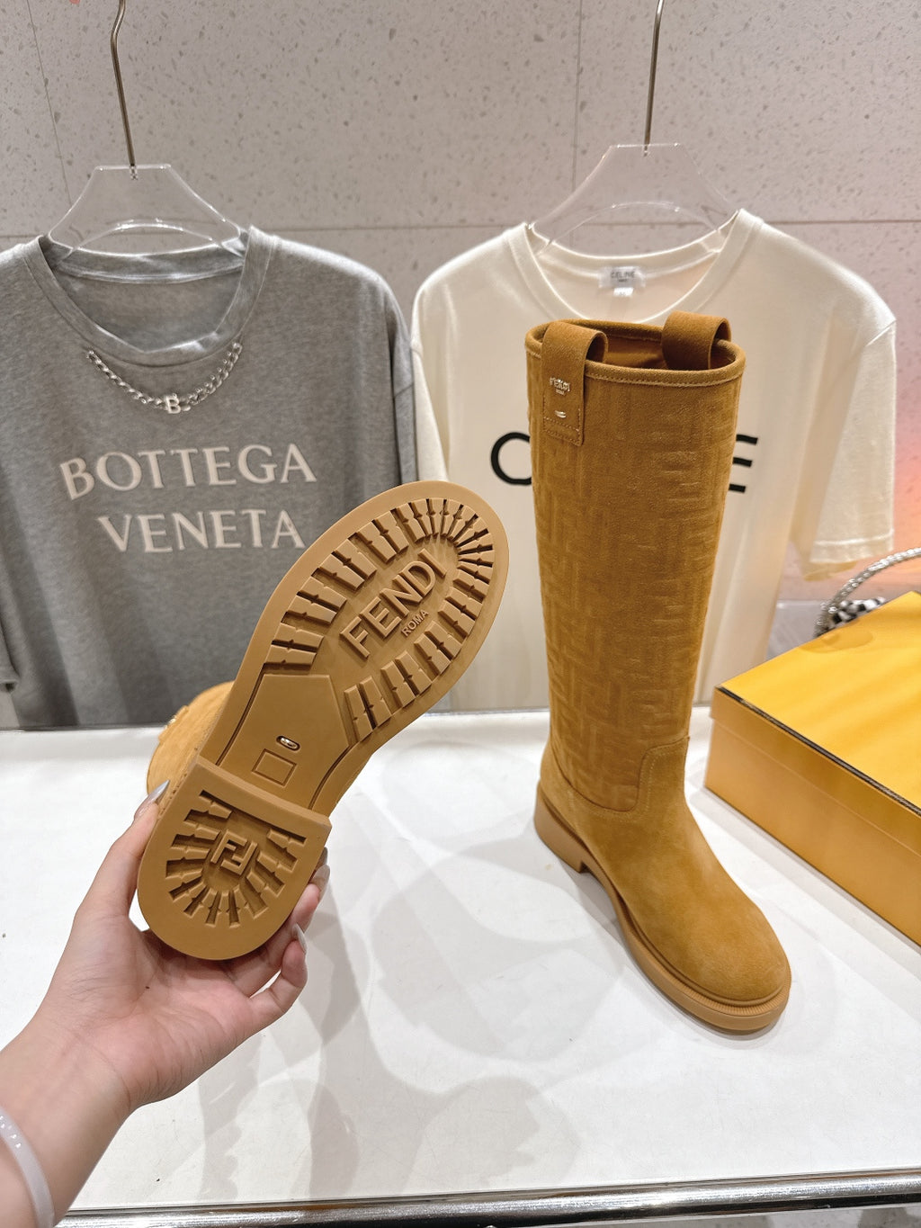 Tan knee-high boots with treaded outsole visible and pull-on upper