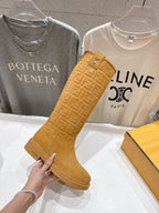 Tan suede knee-high boots with woven-style texture and side tab closure
