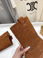 Brown Fendi suede mid-calf boot close-up, embossed logo panel and strap detail