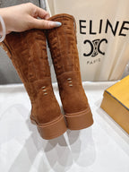 Brown Fendi mid-calf suede boots held up, top edge and pull-on opening visible