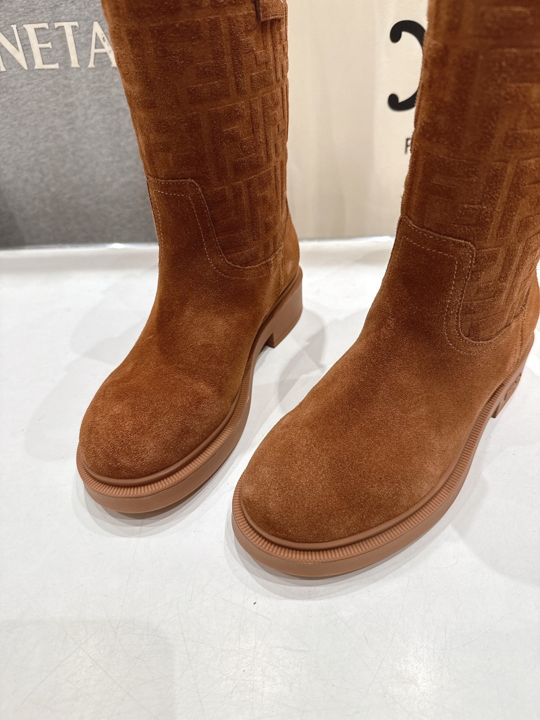 Brown Fendi mid-calf suede boots, close-up of toe and low rubber sole
