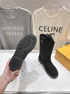 Bottom view of black Fendi mid-calf boots with treaded rubber sole