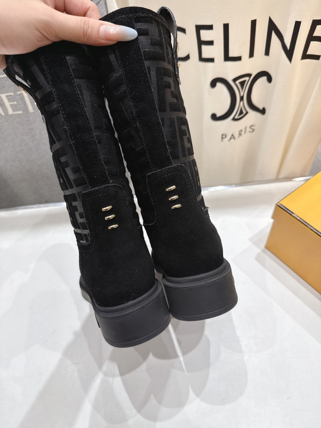 Black Fendi mid-calf boots with tall cuff, FF monogram sides, and platform sole