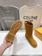 Women’s tan suede ankle boots showing Fendi-branded textured outsole