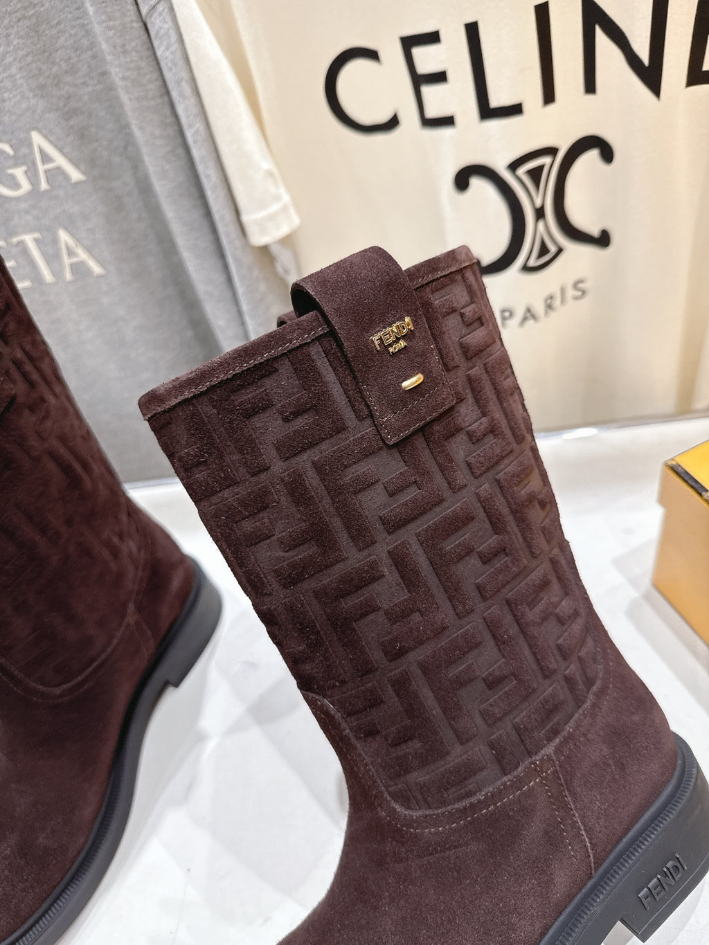 Brown suede tall ankle boots with embossed Fendi FF texture and buckle strap