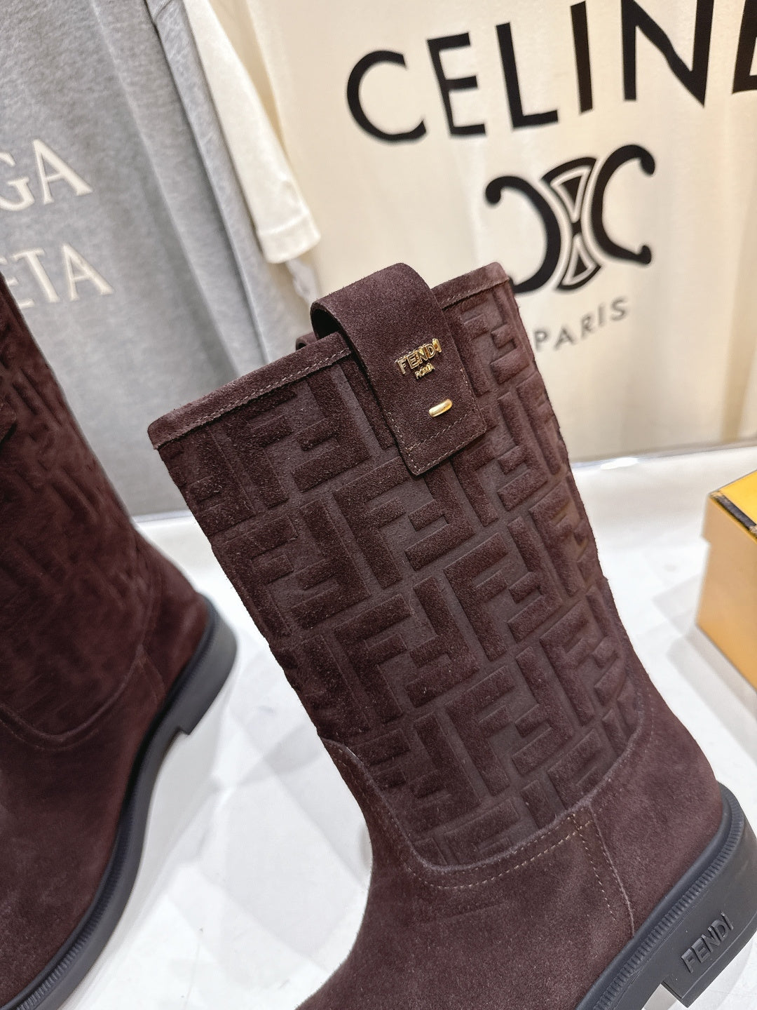 Brown suede tall ankle boots with embossed Fendi FF texture and buckle strap