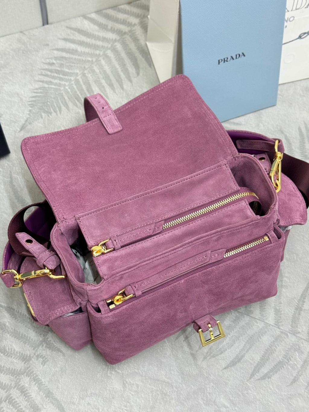 Purple suede mini crossbody bag with front zip pockets and gold-tone zipper pulls