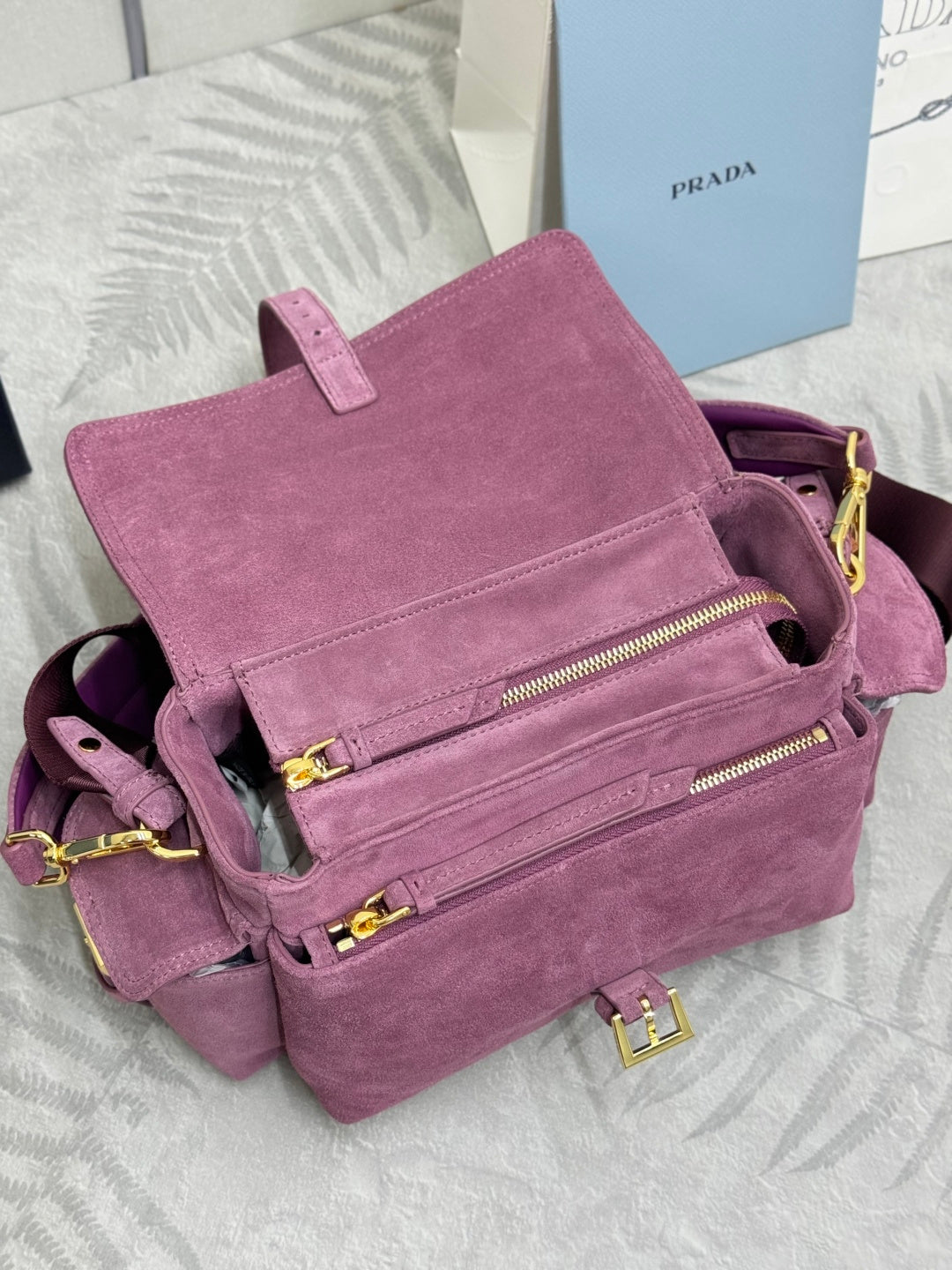 Purple suede mini crossbody bag with front zip pockets and gold-tone zipper pulls