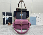Purple suede shoulder bag with top handle, flap front, and adjustable crossbody strap