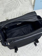 Black Prada nylon bag showing front zipper compartments and silver zipper pulls