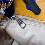Yellow leather bag with silver zipper pull and Louis Vuitton logo tag