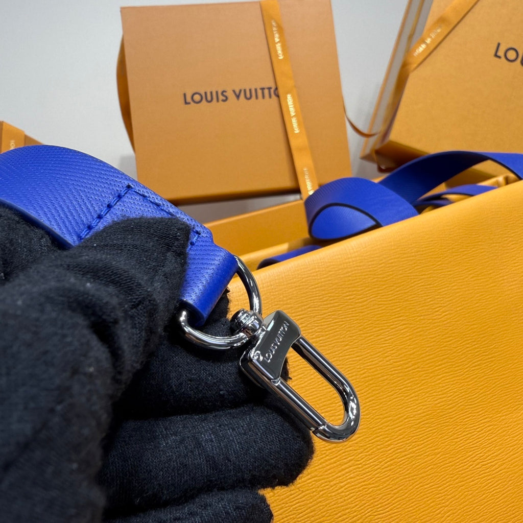 Yellow leather bag with metal clasp and blue strap loop on side