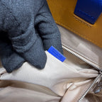 Beige bag lining with metal zipper and blue fabric brand tag