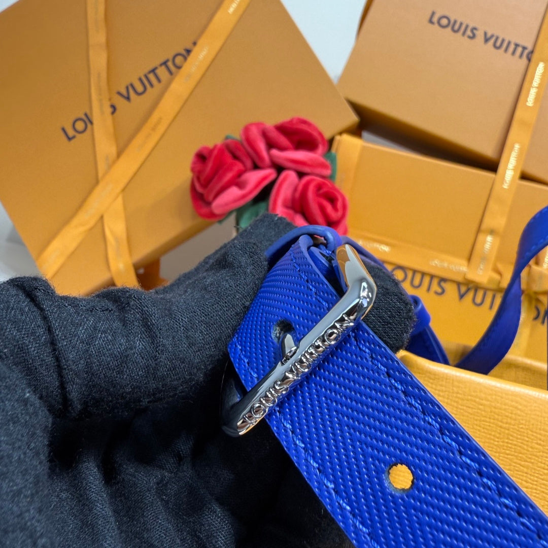 Blue leather strap with silver buckle and small yellow accent dot