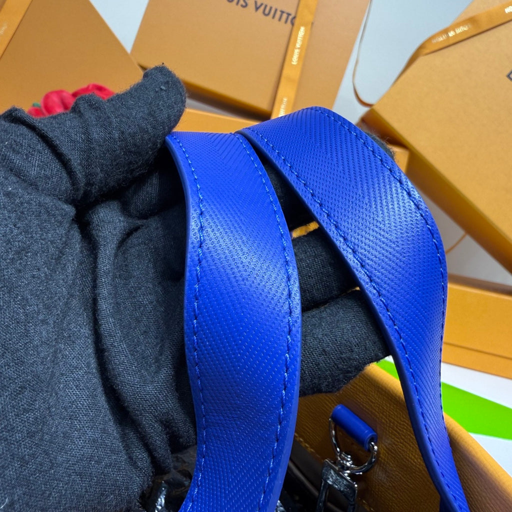 Blue leather strap with visible stitching and metal hardware attachment