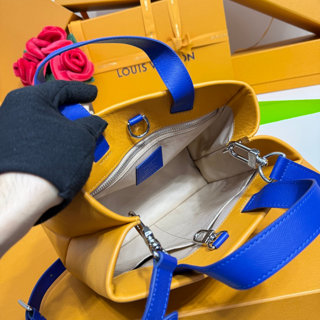 Yellow leather bag interior with blue handle straps and silver hardware
