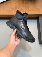 Close-up of Prada dark leather winter sneaker with shearling collar and lace-up eyelets