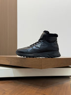 Side view of Prada dark leather winter sneaker with shearling lining and lace-up closure