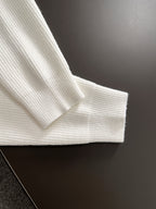 White knit sweater sleeve cuff and shoulder seam