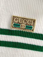 Gucci logo patch on white knit fabric with green stripe band