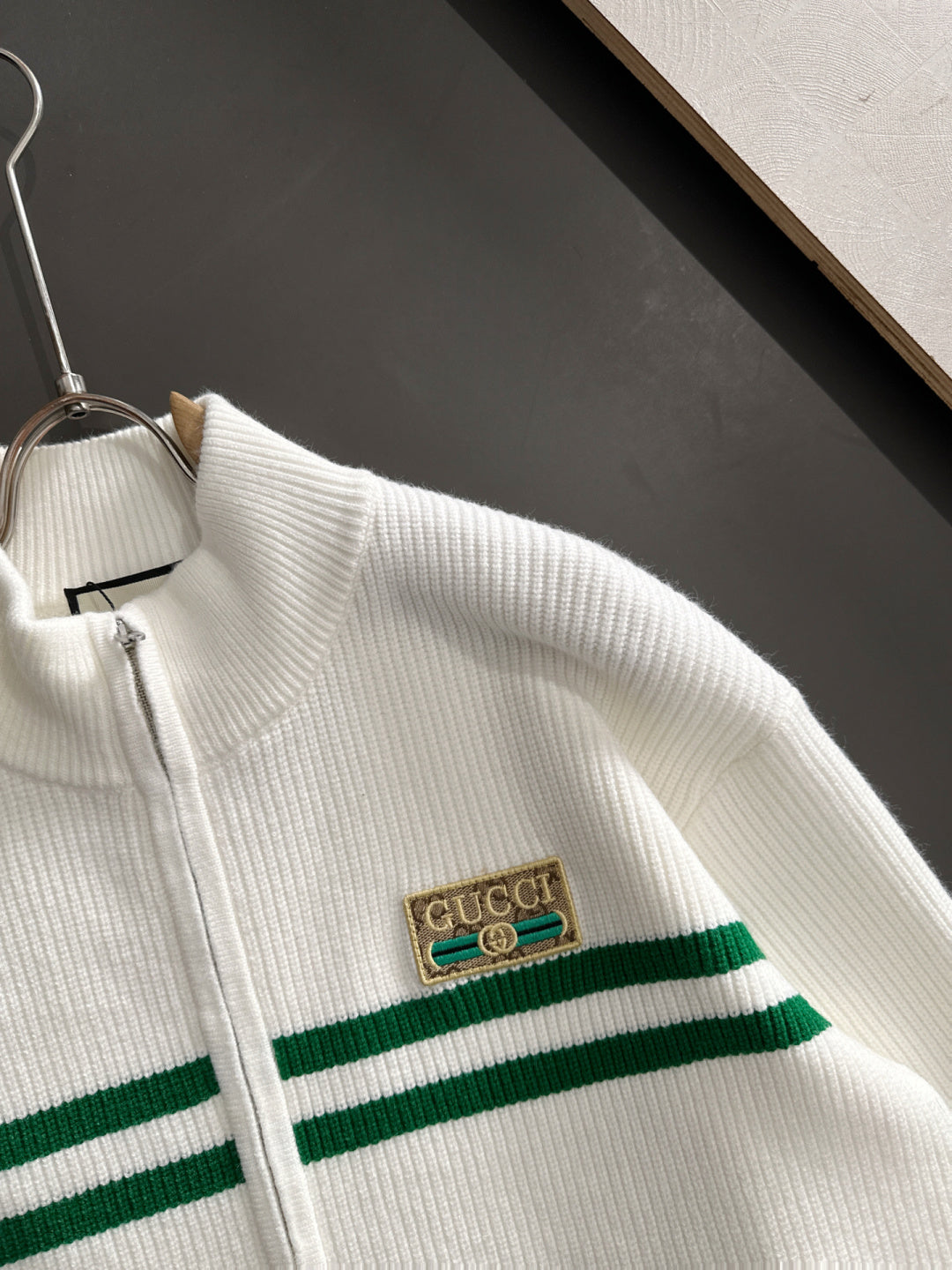 White knit sweater with green stripe band and Gucci logo patch