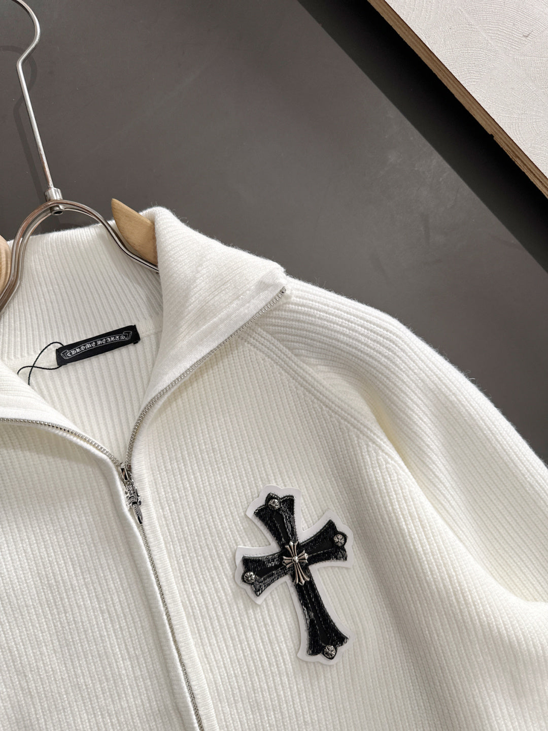 White zip jacket with cross applique at chest and stand collar
