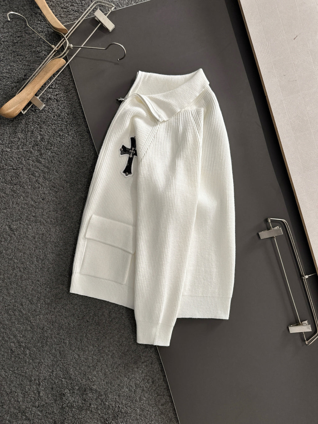 White long-sleeve zip jacket with cross applique and ribbed trim