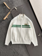 White zip knit sweater with green stripe band and logo patch