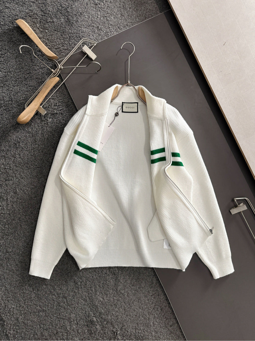 White knit zip sweater with green stripe bands and ribbed collar