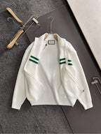 White knit zip sweater with green stripe bands and ribbed collar