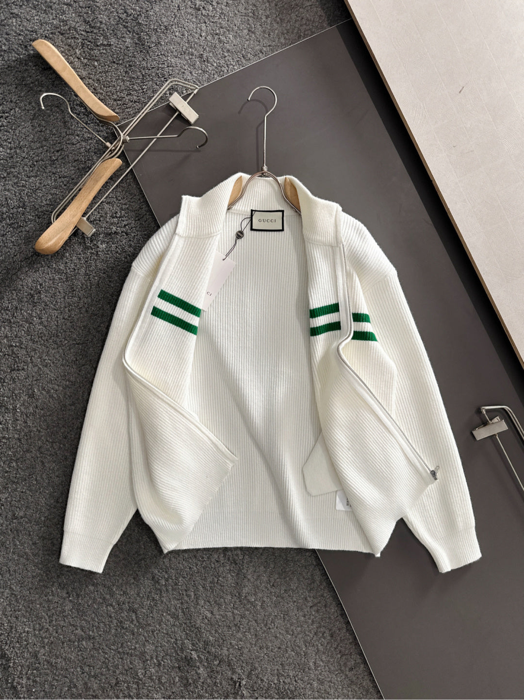 White knit zip sweater with green stripe bands and ribbed collar