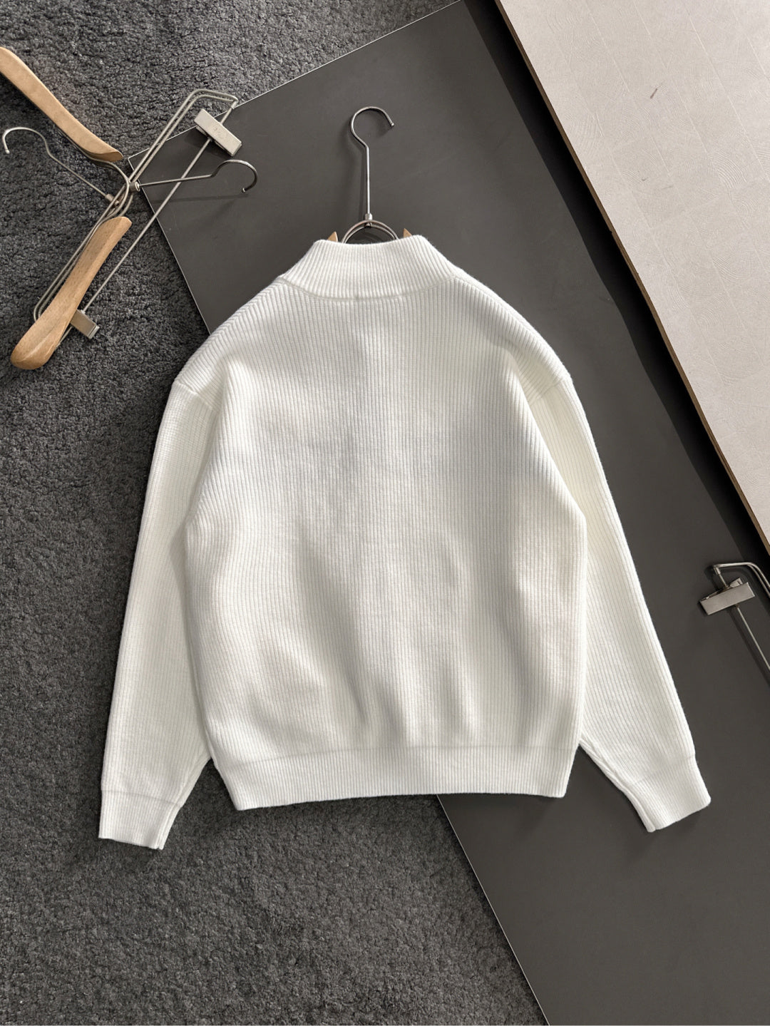 White knit sweater back view with ribbed collar and hem