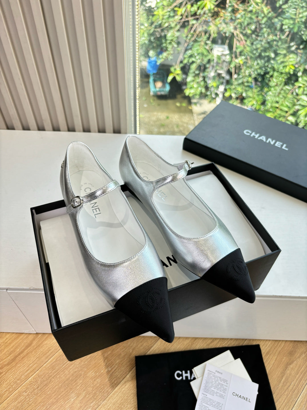 Women’s Chanel two-tone dress flats, silver top with black toe and bow detail