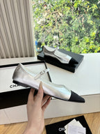 Women’s Chanel silver dress flat with black pointed toe cap and bow strap