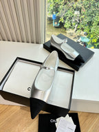 Women’s Chanel two-tone dress flats with silver uppers and black pointed toes