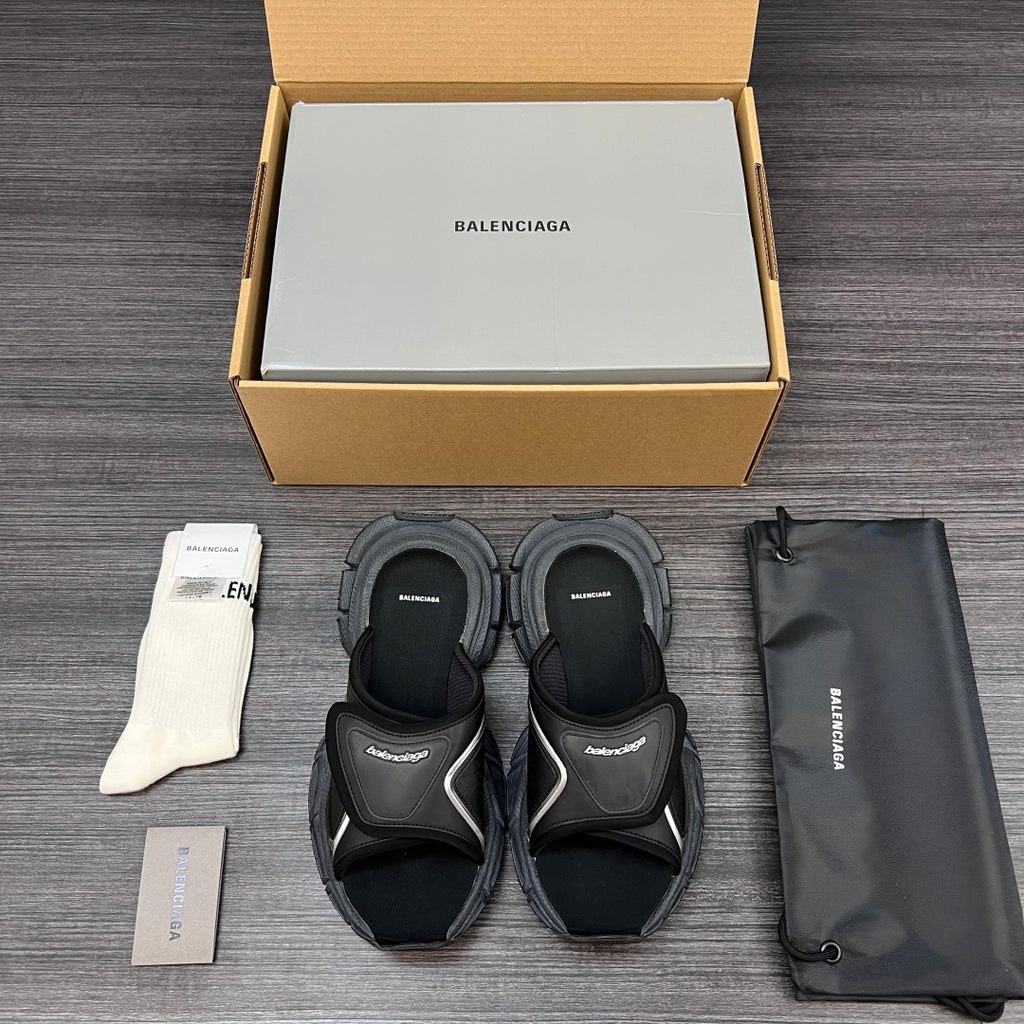 Black sandals with rounded strap design and thick cushioned sole, shown as a paired set.