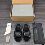 Black sandals with rounded strap design and thick cushioned sole, shown as a paired set.